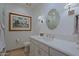 Elegant bathroom with white vanity, large mirror, and updated fixtures at 23335 N Country Club Trl, Scottsdale, AZ 85255