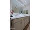 Double vanity bathroom with large mirror and modern finishes at 23335 N Country Club Trl, Scottsdale, AZ 85255