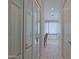 Bathroom hallway with mirrored doors and herringbone tile flooring at 23335 N Country Club Trl, Scottsdale, AZ 85255