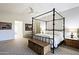 Bright bedroom with a large four-poster bed and ample natural light at 23335 N Country Club Trl, Scottsdale, AZ 85255