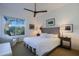 Guest bedroom with comfortable king-size bed and seating area at 23335 N Country Club Trl, Scottsdale, AZ 85255