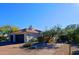 Two-car garage and desert landscaping with mature trees at 23335 N Country Club Trl, Scottsdale, AZ 85255