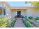 Inviting entryway with landscaped walkway and security door at 23335 N Country Club Trl, Scottsdale, AZ 85255