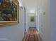 Bright hallway with artwork and patterned rug at 23335 N Country Club Trl, Scottsdale, AZ 85255