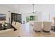 Open living and dining area with tile floors and access to patio at 23335 N Country Club Trl, Scottsdale, AZ 85255