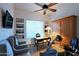 Home office with built-in shelving, comfortable seating, and exercise equipment at 23335 N Country Club Trl, Scottsdale, AZ 85255