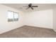 Well-lit bedroom with ceiling fan and neutral carpeting at 24520 W Duane Ln, Wittmann, AZ 85361