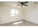 Bright bedroom with tile flooring and ceiling fan at 24520 W Duane Ln, Wittmann, AZ 85361