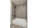Bathroom with tub shower combo and tile surround at 24604 W Duane Ln, Wittmann, AZ 85361