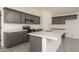 Spacious kitchen with dark cabinetry, quartz countertops, and stainless steel appliances at 24604 W Duane Ln, Wittmann, AZ 85361