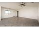 Spacious living area with tile floors and a ceiling fan at 24604 W Duane Ln, Wittmann, AZ 85361