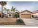 Single-story home with desert landscaping and a two-car garage at 2523 E Taro Ln, Phoenix, AZ 85050