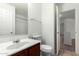 Cozy bathroom with vanity, toilet, and open doorway, all kept bright with neutral colors at 2716 W Allens Peak Dr, San Tan Valley, AZ 85144