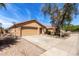 A single-story house with a tile roof and a two-car garage complemented by low-maintenance landscaping at 2716 W Allens Peak Dr, San Tan Valley, AZ 85144