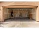 View of the spacious two-car garage with access door, and lots of storage space at 2716 W Allens Peak Dr, San Tan Valley, AZ 85144