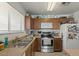 Kitchen features wood cabinets, stainless steel appliances, and double sink at 2716 W Allens Peak Dr, San Tan Valley, AZ 85144