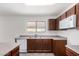 Efficient kitchen with brown cabinets, and white appliances, offering a practical cooking space at 2716 W Allens Peak Dr, San Tan Valley, AZ 85144