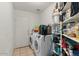 Laundry room with washer, dryer, and storage shelving at 2716 W Allens Peak Dr, San Tan Valley, AZ 85144