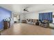 Bright living room with tile floors, a ceiling fan, and access to a patio at 2716 W Allens Peak Dr, San Tan Valley, AZ 85144