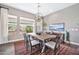 Bright dining room features a rustic wood table, chandelier, and large windows at 28623 N Sweep Ct, Rio Verde, AZ 85263