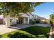 Backyard view with patio, lush lawn, and string lights at 3146 E Sagebrush St, Gilbert, AZ 85296