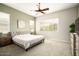 Spacious bedroom with large windows, ceiling fan, and plush carpet at 3146 E Sagebrush St, Gilbert, AZ 85296