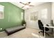 Bedroom with green accent wall, window blinds, and workspace at 3146 E Sagebrush St, Gilbert, AZ 85296