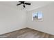 Simple bedroom with a window, wood-look floors, and ceiling fan at 316 E El Camino Dr, Phoenix, AZ 85020