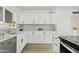 Newly renovated kitchen with white shaker cabinets and a stylish backsplash at 316 E El Camino Dr, Phoenix, AZ 85020