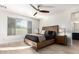 Main bedroom with wood platform bed and ensuite bathroom at 3170 S Nebraska St, Chandler, AZ 85248