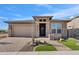 Modern home with stone and stucco exterior, 2-car garage, and landscaped front yard at 32978 N 131St Dr, Peoria, AZ 85383