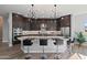 Modern kitchen with island and granite countertops, black barstools at 32978 N 131St Dr, Peoria, AZ 85383