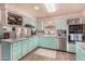 Well-lit kitchen showcases stainless appliances, a large sink, and charming light-colored cabinets at 4953 E Farmdale Ave, Mesa, AZ 85206