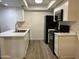 Modern kitchen with white cabinets and black appliances at 520 N Stapley Dr # 290, Mesa, AZ 85203