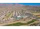 Aerial view of Mountainbrook Village, showing homes, golf course, pool, and tennis courts at 5363 S Emerald Desert Dr, Gold Canyon, AZ 85118