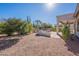 Relaxing backyard with patio, grill, and desert landscaping at 5363 S Emerald Desert Dr, Gold Canyon, AZ 85118