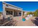 Spacious backyard with covered patio, bird bath, and landscaping at 5363 S Emerald Desert Dr, Gold Canyon, AZ 85118