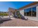 Covered patio, adjacent to house, with desert landscaping at 5363 S Emerald Desert Dr, Gold Canyon, AZ 85118