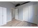 Bedroom with wood floors, white closet doors, and access to another room at 5363 S Emerald Desert Dr, Gold Canyon, AZ 85118