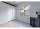 Bedroom with wood floors, white closet doors, and window with blinds at 5363 S Emerald Desert Dr, Gold Canyon, AZ 85118