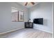 Bedroom with wood floors, corner cabinet, and wall-mounted TV at 5363 S Emerald Desert Dr, Gold Canyon, AZ 85118