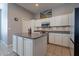 Kitchen with island, stainless steel appliances, and white cabinets at 5363 S Emerald Desert Dr, Gold Canyon, AZ 85118