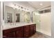Elegant bathroom with double vanity, large mirror, and a separate shower at 5715 N 105Th Ln, Glendale, AZ 85307