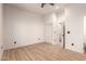 Light and airy bedroom with wood-look flooring and access to a bathroom at 5715 N 105Th Ln, Glendale, AZ 85307