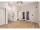 Bright bedroom with patio access and wood-look flooring at 5715 N 105Th Ln, Glendale, AZ 85307