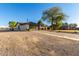 Single story home with a large driveway and mature tree at 5715 N 105Th Ln, Glendale, AZ 85307