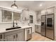 Modern kitchen with stainless steel appliances and a farmhouse sink at 5715 N 105Th Ln, Glendale, AZ 85307