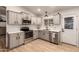 Modern kitchen featuring stainless steel appliances and light cabinets at 5715 N 105Th Ln, Glendale, AZ 85307