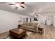 Bright living room with a large sofa and wood flooring at 5715 N 105Th Ln, Glendale, AZ 85307