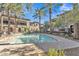 Community pool with surrounding patio and palm trees at 6565 E Thomas Rd # 1091, Scottsdale, AZ 85251